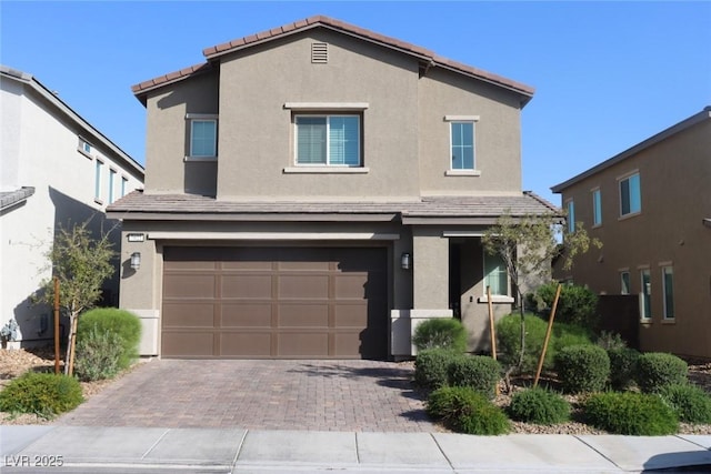 7022 Judith River St, North Las Vegas, NV 89084 - view of front facade with stucco siding, an attached garage, driveway, and a tile roof