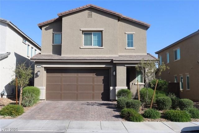 7022 Judith River St, North Las Vegas, NV 89084 - view of front of property with stucco siding, a garage, decorative driveway, and a tile roof