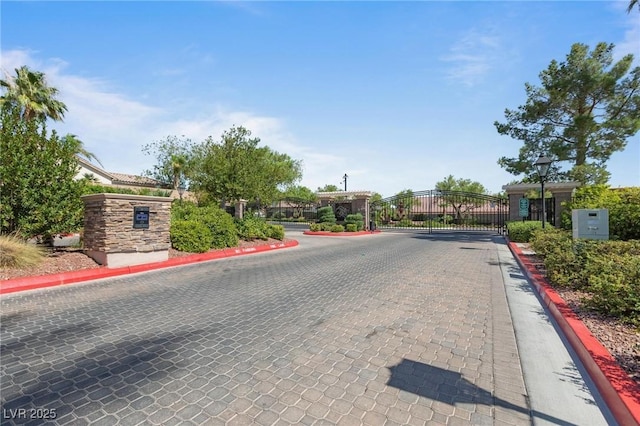 10596 Refugio St, Las Vegas, NV 89141 - view of road featuring curbs, a gate, street lights, and a gated entry