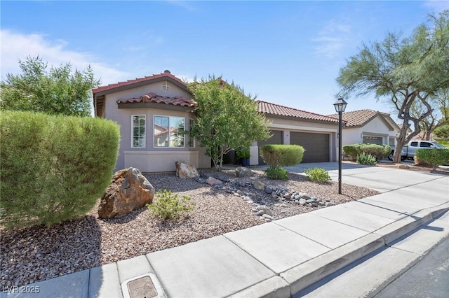 10596 Refugio St, Las Vegas, NV 89141 - mediterranean / spanish-style home featuring driveway, a garage, stucco siding, and a tile roof