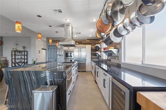 10596 Refugio St, Las Vegas, NV 89141 - kitchen with appliances with stainless steel finishes, island range hood, wine cooler, white cabinets, and dark stone countertops