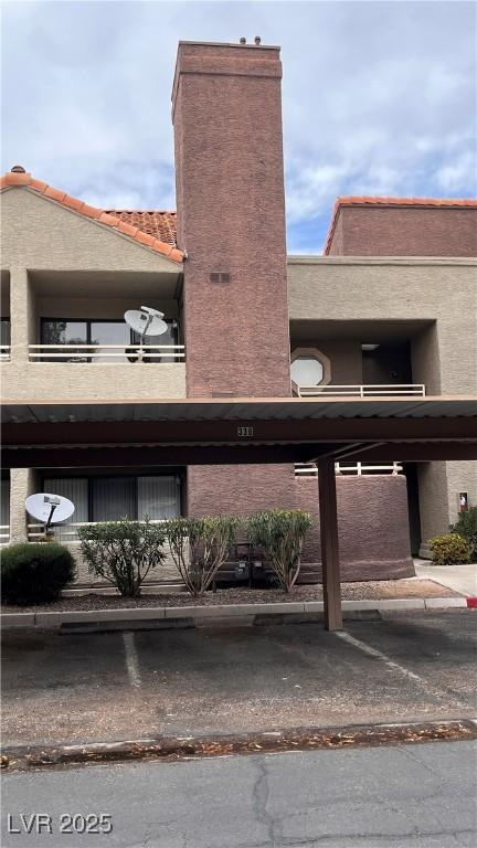 5016 S Rainbow Blvd Unit 206, Las Vegas, NV 89118 - view of property featuring covered parking