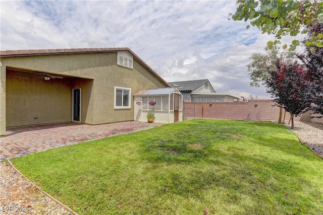 4441 Glossier Ave, North Las Vegas, NV 89084 - fenced backyard with a patio area and an outbuilding