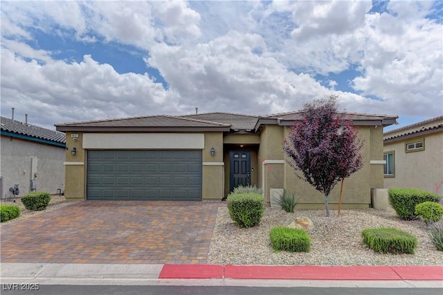 4441 Glossier Ave, North Las Vegas, NV 89084 - view of front facade featuring stucco siding, an attached garage, driveway, and a tile roof