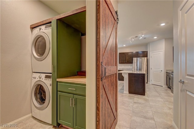4441 Glossier Ave, North Las Vegas, NV 89084 - laundry room with stacked washer / dryer, light tile patterned floors, and recessed lighting