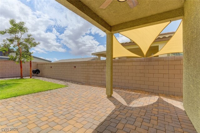 4441 Glossier Ave, North Las Vegas, NV 89084 - fenced backyard featuring a ceiling fan and a patio