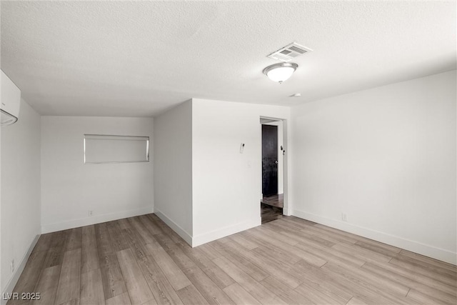 1915 Balboa Ave, Las Vegas, NV 89169 - unfurnished bedroom with light wood-style flooring and a textured ceiling
