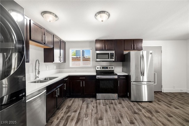 1915 Balboa Ave, Las Vegas, NV 89169 - kitchen with appliances with stainless steel finishes, wood finished floors, light countertops, and dark brown cabinetry