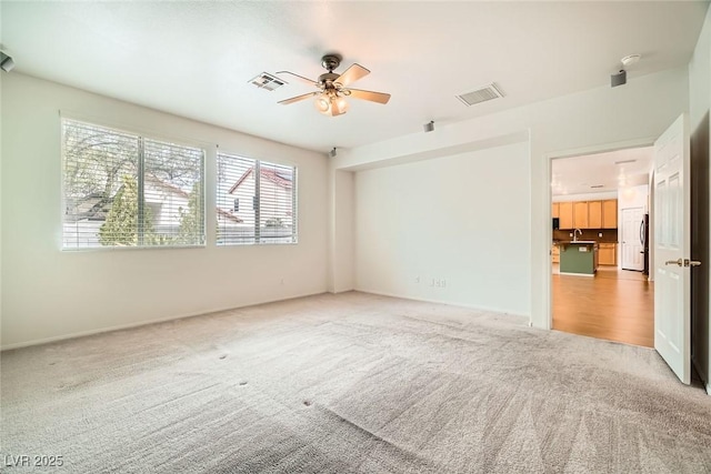 262 Pebble Canyon Dr, Las Vegas, NV 89123 - empty room with light colored carpet and a ceiling fan