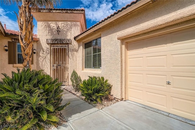 262 Pebble Canyon Dr, Las Vegas, NV 89123 - property entrance with stucco siding, a tile roof, and an attached garage