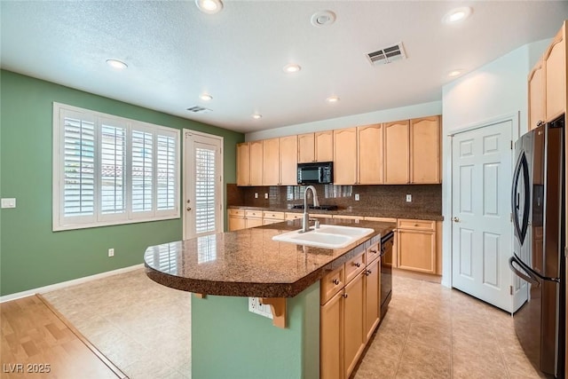 262 Pebble Canyon Dr, Las Vegas, NV 89123 - kitchen featuring black appliances, light brown cabinets, backsplash, dark countertops, and recessed lighting
