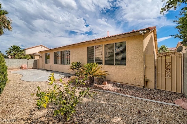 262 Pebble Canyon Dr, Las Vegas, NV 89123 - rear view of house featuring stucco siding, a patio, and a tiled roof