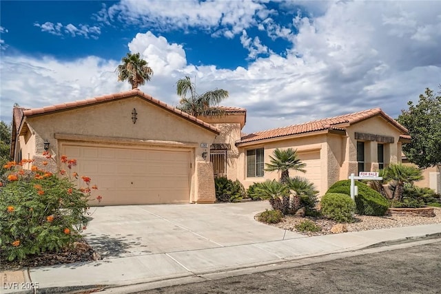 262 Pebble Canyon Dr, Las Vegas, NV 89123 - mediterranean / spanish-style home with an attached garage, stucco siding, concrete driveway, and a tiled roof