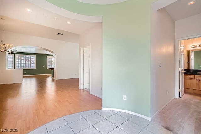 262 Pebble Canyon Dr, Las Vegas, NV 89123 - unfurnished room with arched walkways, a chandelier, light wood-style flooring, and recessed lighting