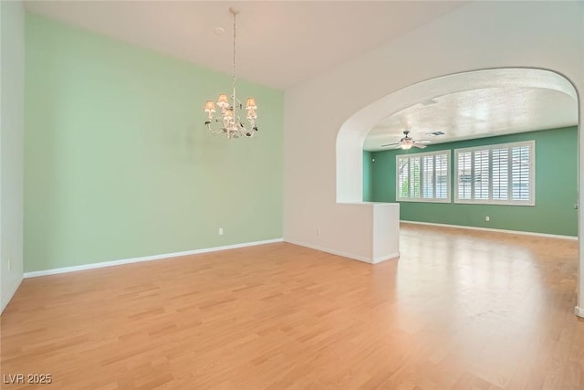262 Pebble Canyon Dr, Las Vegas, NV 89123 - spare room with arched walkways, light wood-type flooring, ceiling fan, and a chandelier