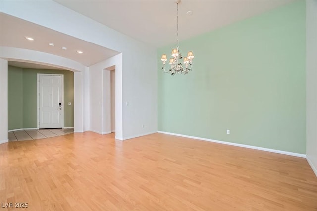 262 Pebble Canyon Dr, Las Vegas, NV 89123 - spare room featuring light wood finished floors, a chandelier, recessed lighting, and arched walkways