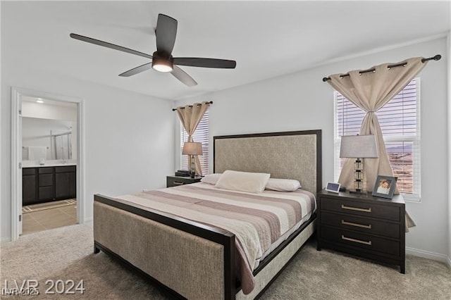 10106 Queens Pearl St, Las Vegas, NV 89141 - bedroom featuring light colored carpet, ensuite bathroom, and ceiling fan