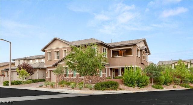 5676 Corona Vista St, Las Vegas, NV 89135 - multi unit property featuring a garage, stucco siding, a balcony, stone siding, and driveway