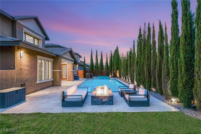 5676 Corona Vista St, Las Vegas, NV 89135 - pool at dusk featuring a patio, a yard, and a fire pit