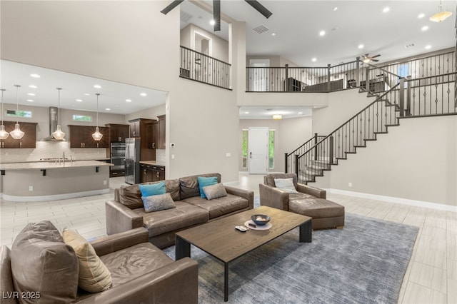 5676 Corona Vista St, Las Vegas, NV 89135 - living area with ceiling fan, stairs, recessed lighting, a towering ceiling, and light tile patterned floors