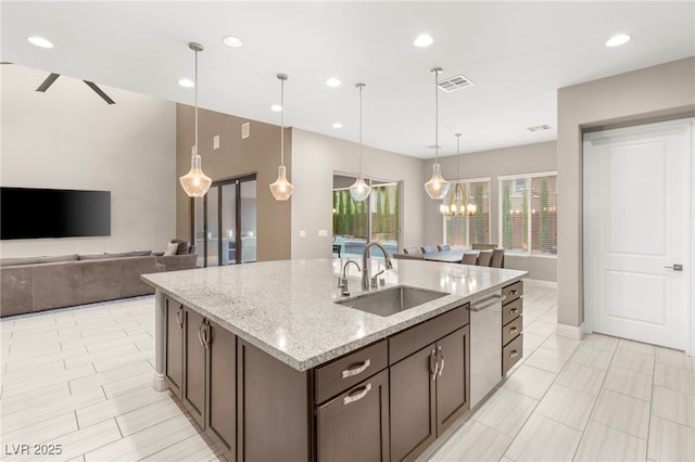 5676 Corona Vista St, Las Vegas, NV 89135 - kitchen with stainless steel dishwasher, dark brown cabinetry, a center island with sink, plenty of natural light, and recessed lighting