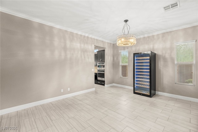5676 Corona Vista St, Las Vegas, NV 89135 - empty room featuring a chandelier, crown molding, and wine cooler