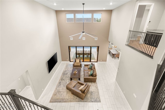 5676 Corona Vista St, Las Vegas, NV 89135 - living area with ceiling fan, a high ceiling, and recessed lighting
