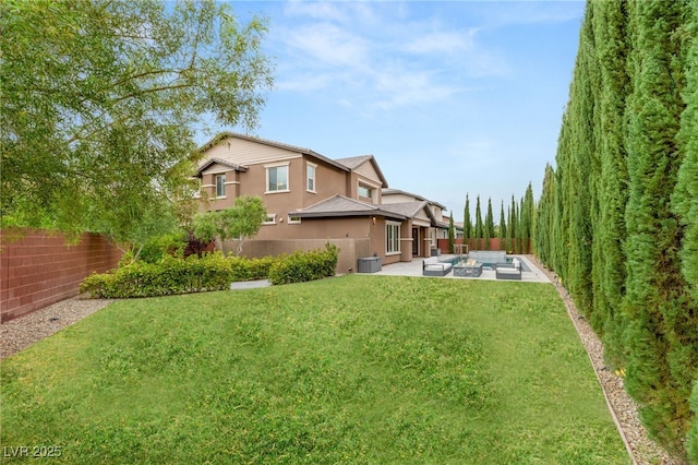 5676 Corona Vista St, Las Vegas, NV 89135 - back of house featuring a patio area, a fenced backyard, stucco siding, and an outdoor living space