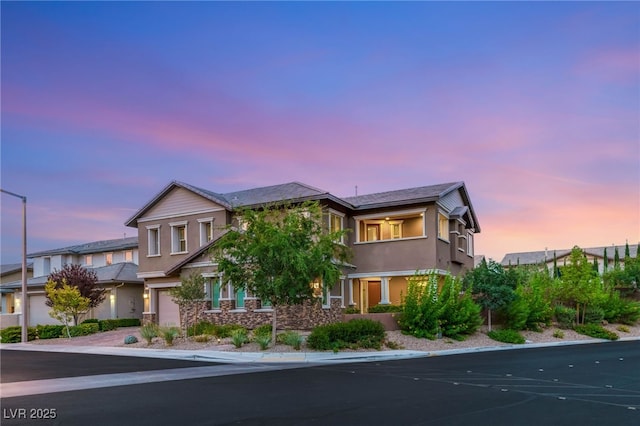 5676 Corona Vista St, Las Vegas, NV 89135 - view of front of house with stucco siding, a garage, and stone siding