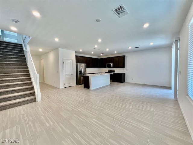 8003 Adelaide Hills St, Las Vegas, NV 89113 - kitchen featuring stainless steel appliances, open floor plan, an island with sink, light countertops, and recessed lighting