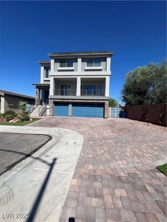 8094 Noble Ridge St, Las Vegas, NV 89139 - view of front facade featuring an attached garage and decorative driveway