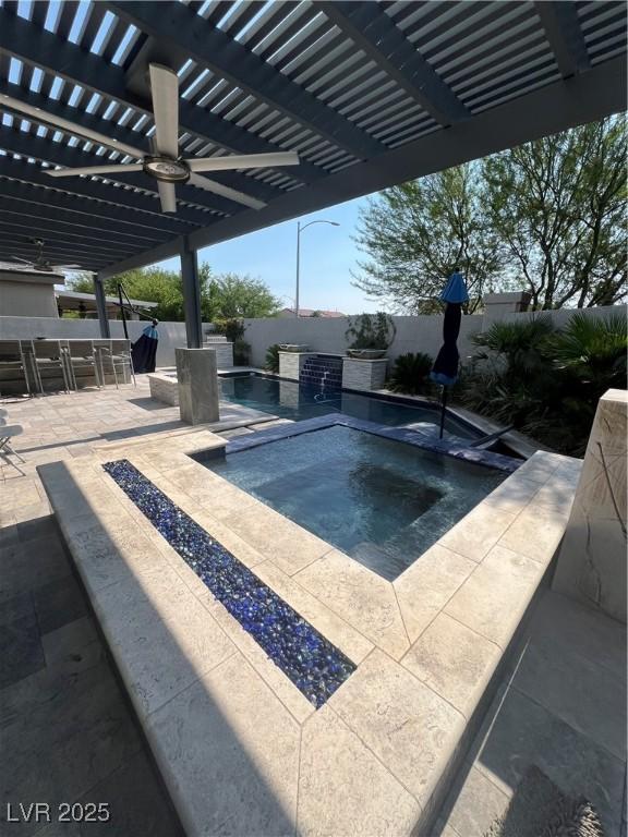 8094 Noble Ridge St, Las Vegas, NV 89139 - view of pool featuring an in-ground hot tub, a pergola, and a fenced backyard
