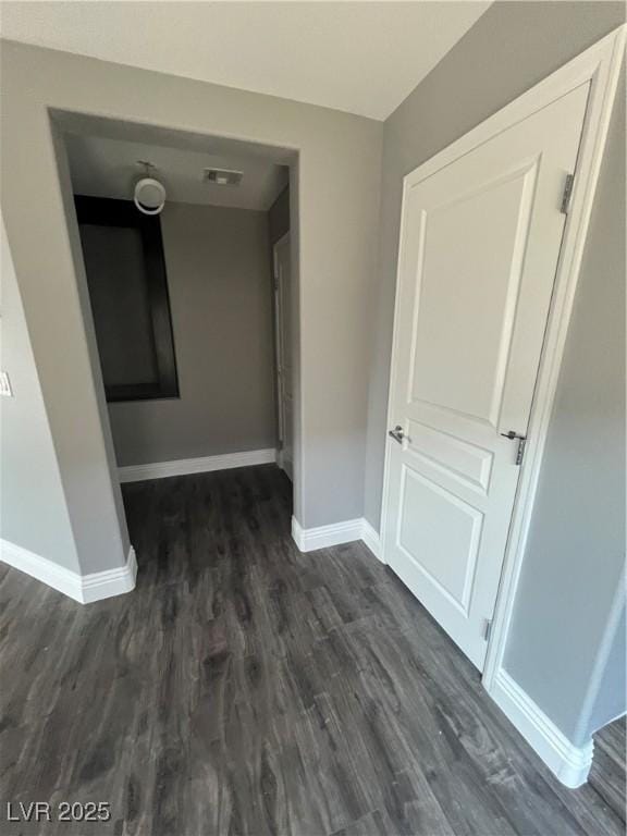 8094 Noble Ridge St, Las Vegas, NV 89139 - hallway featuring baseboards and dark wood-style flooring
