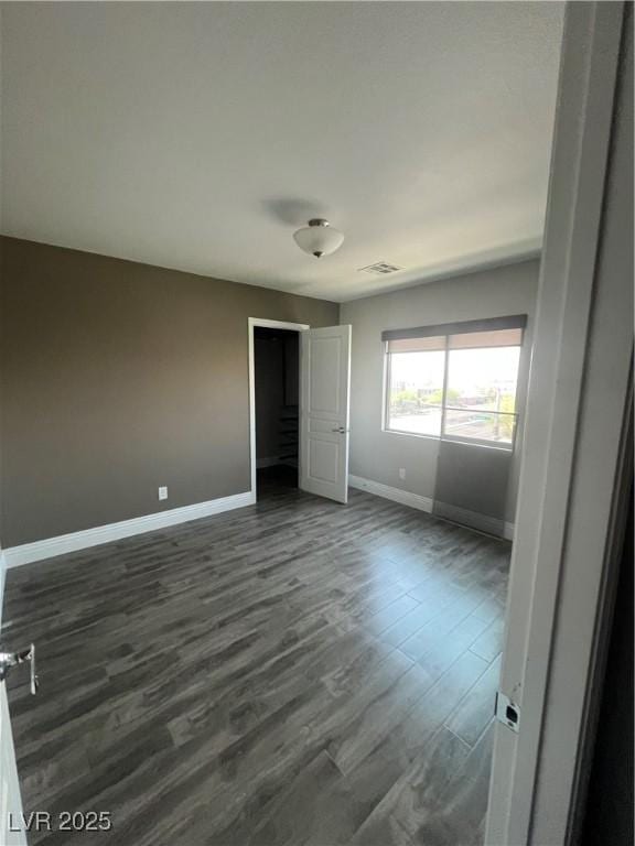 8094 Noble Ridge St, Las Vegas, NV 89139 - unfurnished bedroom with baseboards and dark wood-style floors