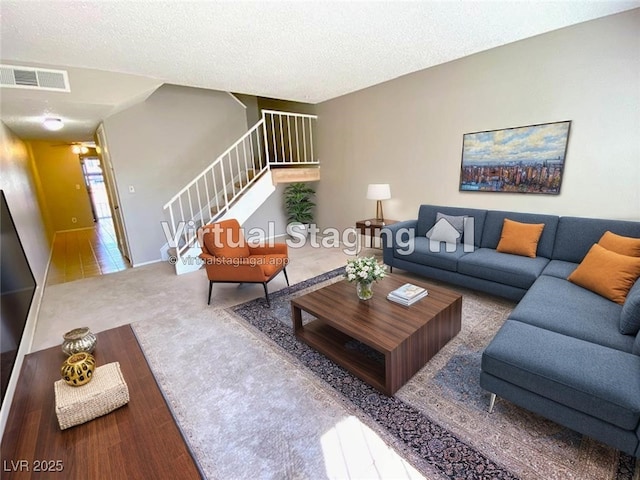 4242 Mississippi Ave, Las Vegas, NV 89103 - carpeted living area with stairs and a textured ceiling