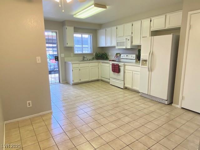 4242 Mississippi Ave, Las Vegas, NV 89103 - kitchen featuring white appliances, light countertops, white cabinetry, and light tile patterned flooring