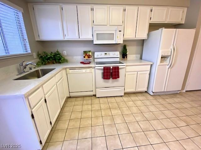 4242 Mississippi Ave, Las Vegas, NV 89103 - kitchen with white appliances, light countertops, and white cabinetry
