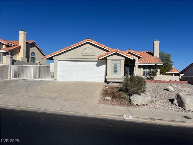 3160 James A Bilbray Pkwy, Laughlin, NV 89029 - view of front of home featuring a garage, driveway, a tiled roof, and stucco siding