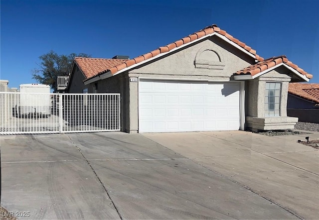 3160 James A Bilbray Pkwy, Laughlin, NV 89029 - view of front of home featuring concrete driveway, a tile roof, and an attached garage