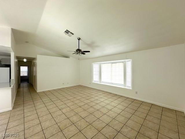 5400 Maddox Ave, Las Vegas, NV 89107 - unfurnished room with ceiling fan, light tile patterned flooring, vaulted ceiling, and plenty of natural light