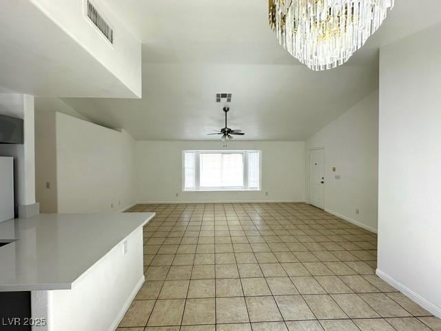 5400 Maddox Ave, Las Vegas, NV 89107 - unfurnished living room featuring a ceiling fan, light tile patterned floors, and a chandelier