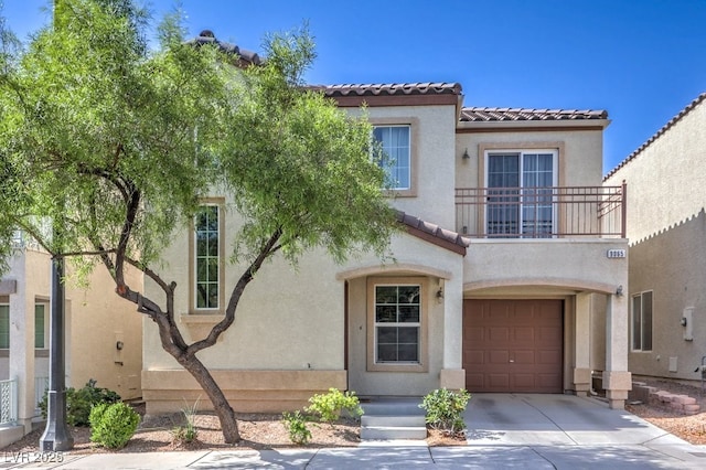 9065 Tantalizing Ave, Las Vegas, NV 89149 - view of front of property with a balcony, a garage, stucco siding, a tile roof, and concrete driveway