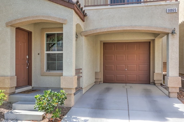 9065 Tantalizing Ave, Las Vegas, NV 89149 - property entrance with stucco siding, driveway, and a garage