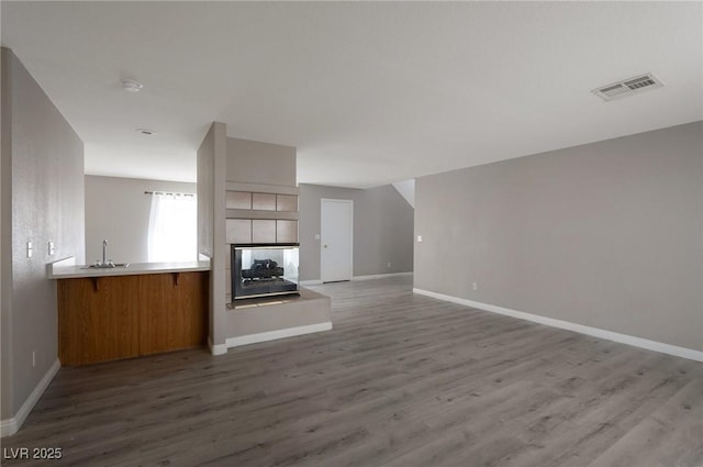 5204 Padua Way, Las Vegas, NV 89107 - unfurnished living room with wood finished floors and a tiled fireplace