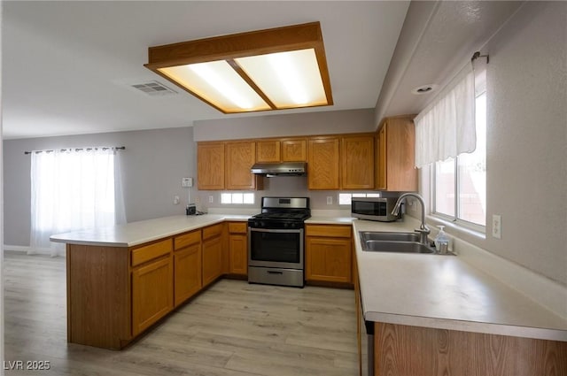 5204 Padua Way, Las Vegas, NV 89107 - kitchen with appliances with stainless steel finishes, a peninsula, under cabinet range hood, and light countertops