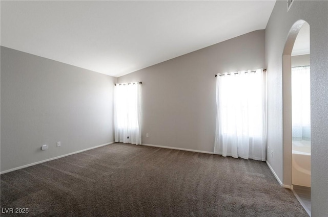 5204 Padua Way, Las Vegas, NV 89107 - carpeted empty room with arched walkways and vaulted ceiling