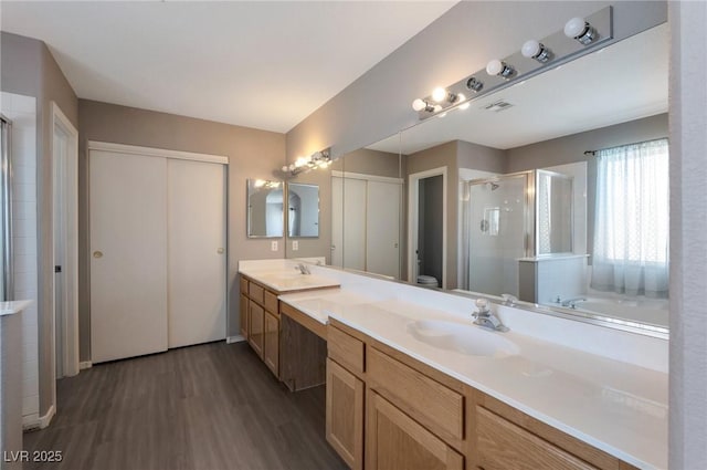 5204 Padua Way, Las Vegas, NV 89107 - full bathroom with a shower stall, double vanity, wood finished floors, and a garden tub