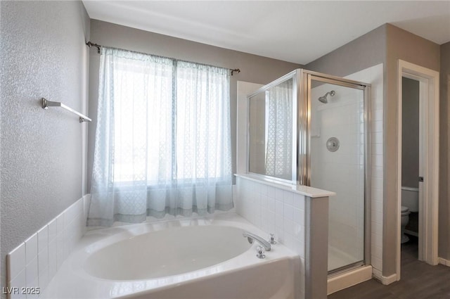 5204 Padua Way, Las Vegas, NV 89107 - full bath with a bath, a stall shower, a textured wall, and wood finished floors