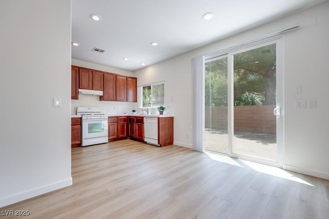 5013 Diamond Ranch Ave, Las Vegas, NV 89131 - kitchen with white appliances, under cabinet range hood, light wood finished floors, light countertops, and recessed lighting