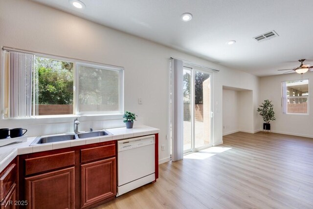 5013 Diamond Ranch Ave, Las Vegas, NV 89131 - kitchen with white dishwasher, healthy amount of natural light, light wood-style floors, ceiling fan, and recessed lighting